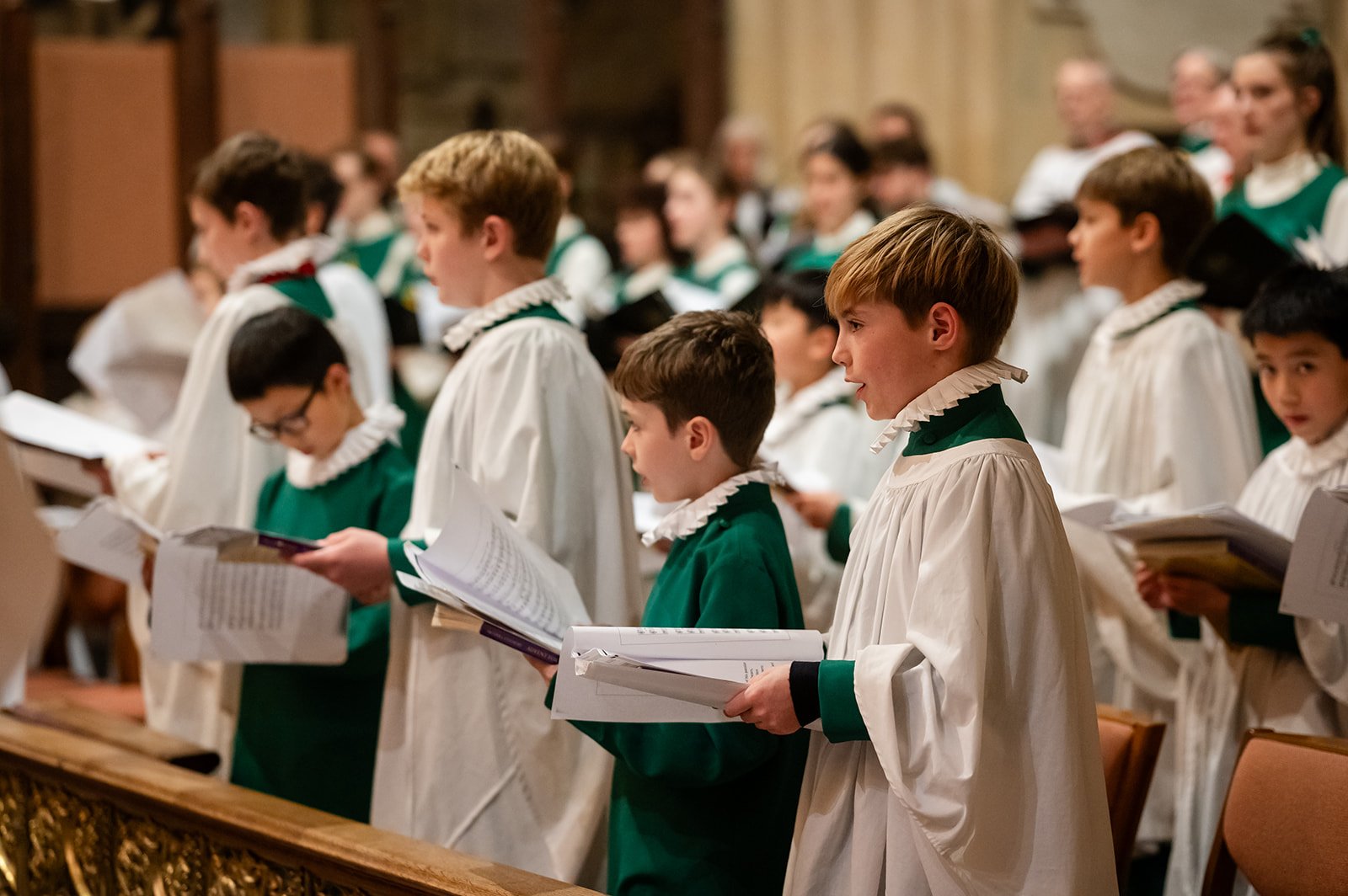 Group of boy choristers standing and singing in Bath Abbey