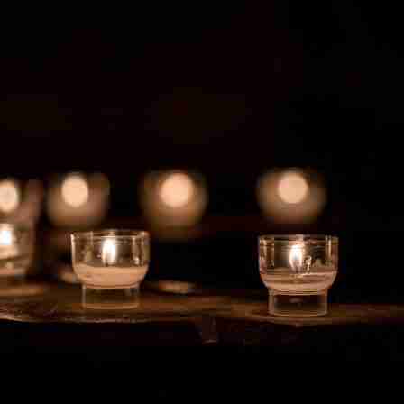 Tea lights in clear candle holders arranged in a semi circle