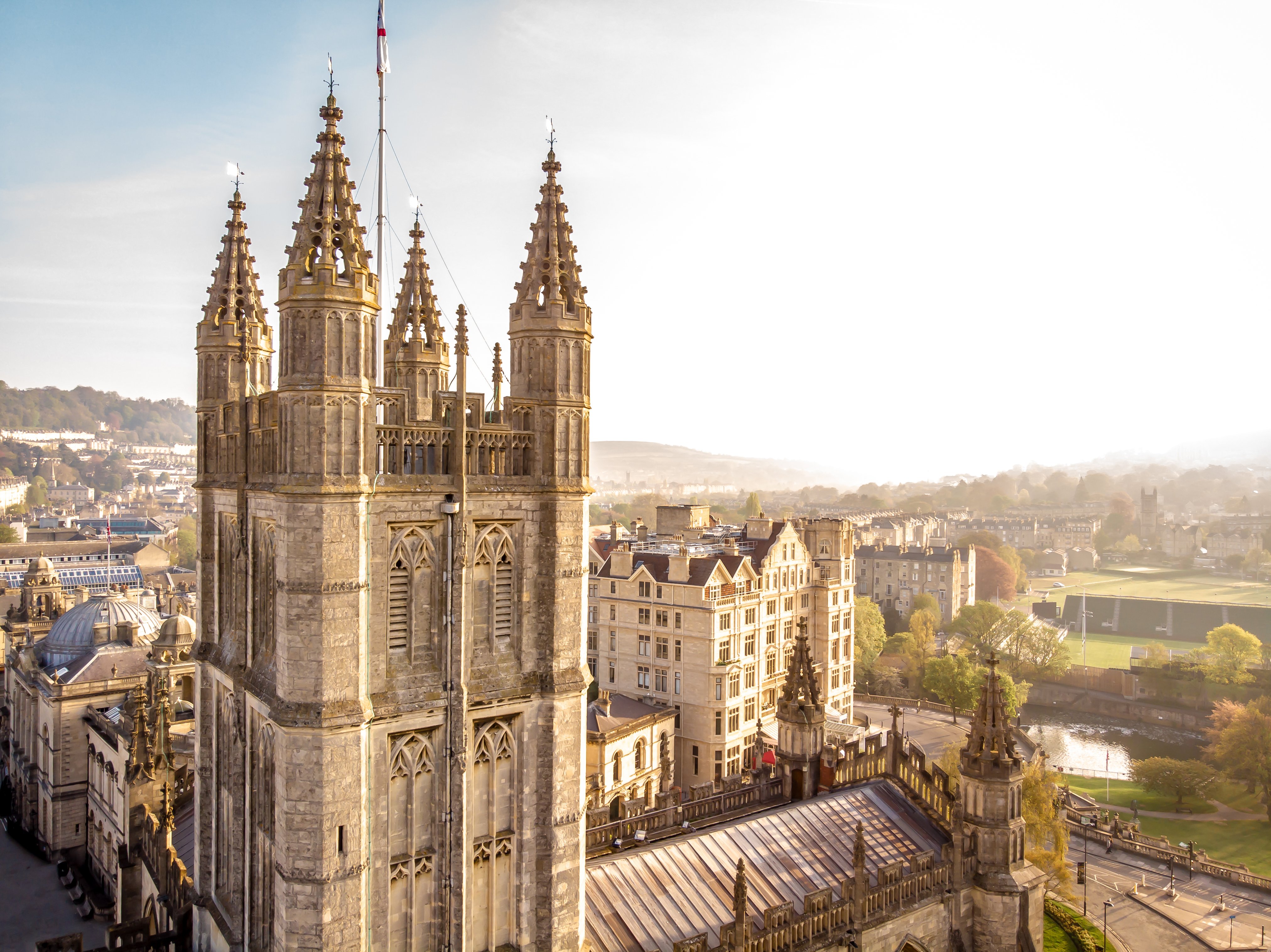 A church tower with the city and sky behind